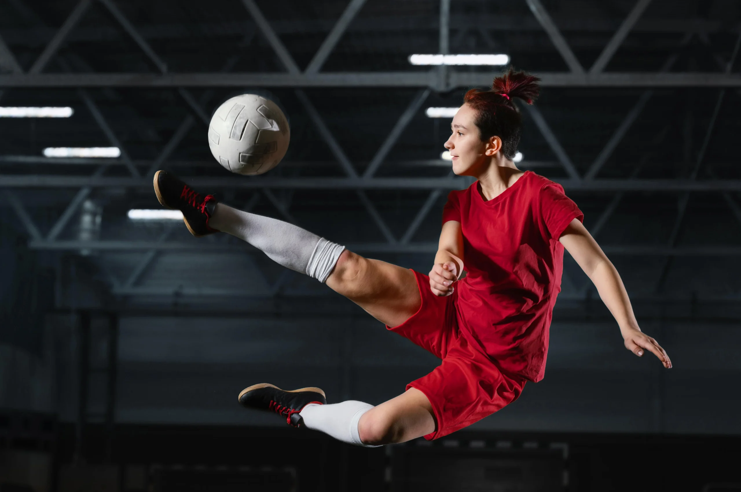 woman-kicking-football-ball